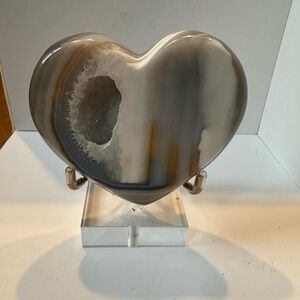 Druzy agate heart carving in glass display